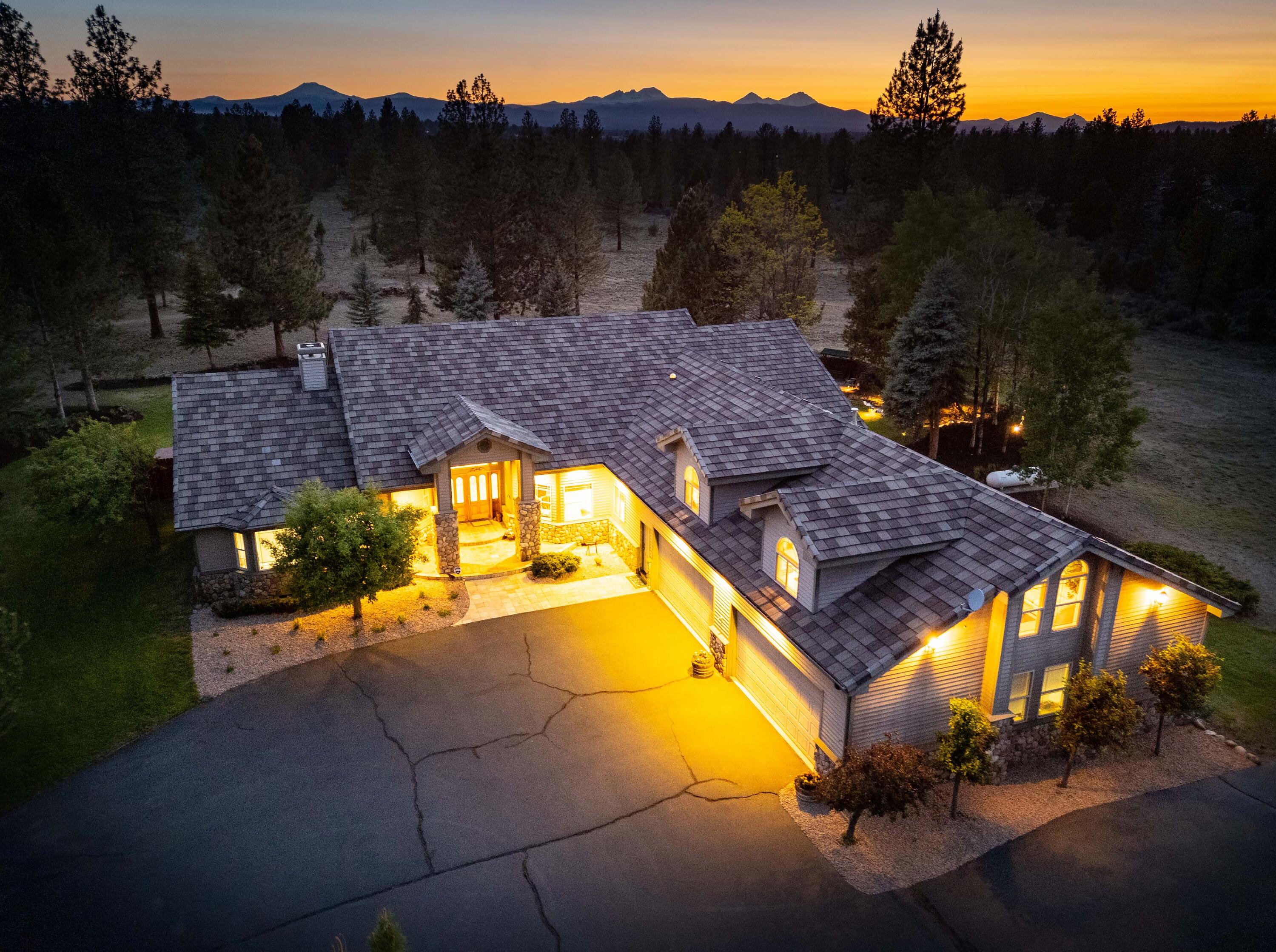 60485 Billadeau Road Bend, OR 97702 - Photo 45 of 47 Front exterior at night with Cascade Mountains, Bend OR