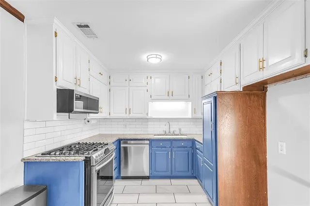 a kitchen with stainless steel appliances granite countertop a refrigerator sink and cabinets