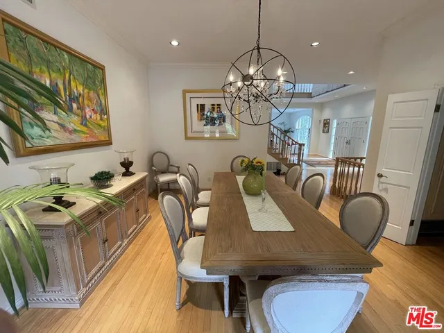 a view of a dining room with furniture wooden floor and chandelier