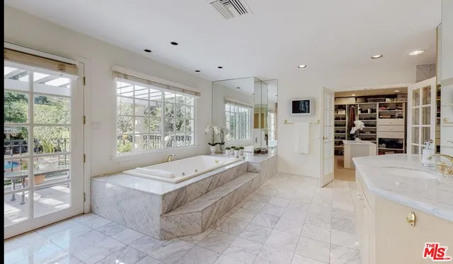 a large spacious bathroom with a large tub and shower