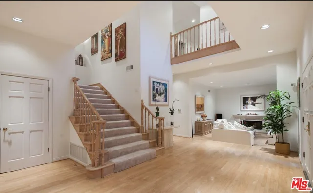 a view of entryway and hall with wooden floor
