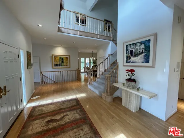 a bedroom with furniture and a wooden floor
