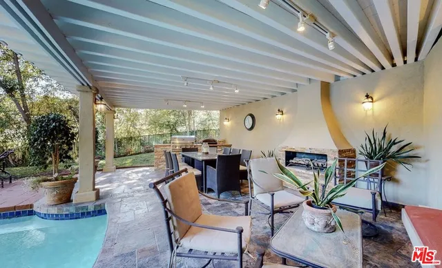 a view of a patio with table and chairs potted plants with wooden floor