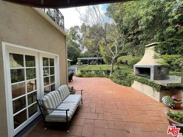 a balcony with furniture and a garden