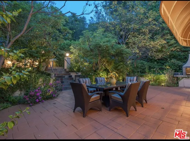 a view of a patio with table and chairs and potted plants