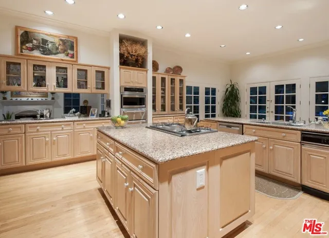a kitchen with stainless steel appliances granite countertop a sink and cabinets