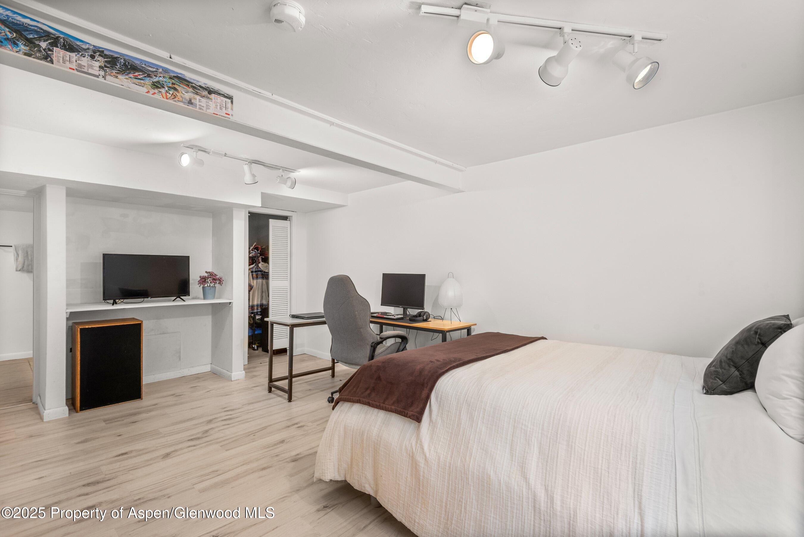 331 Holland Hills Road, Unit 5 Basalt, CO 81621 - Photo 11 of 19 a bedroom with a bed and a flat screen tv