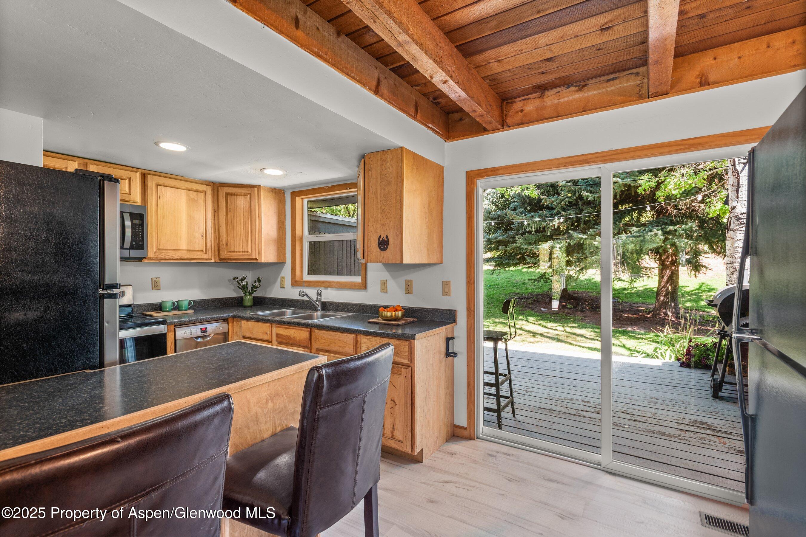 331 Holland Hills Road, Unit 5 Basalt, CO 81621 - Photo 7 of 19 a kitchen with stainless steel appliances granite countertop sink stove and refrigerator