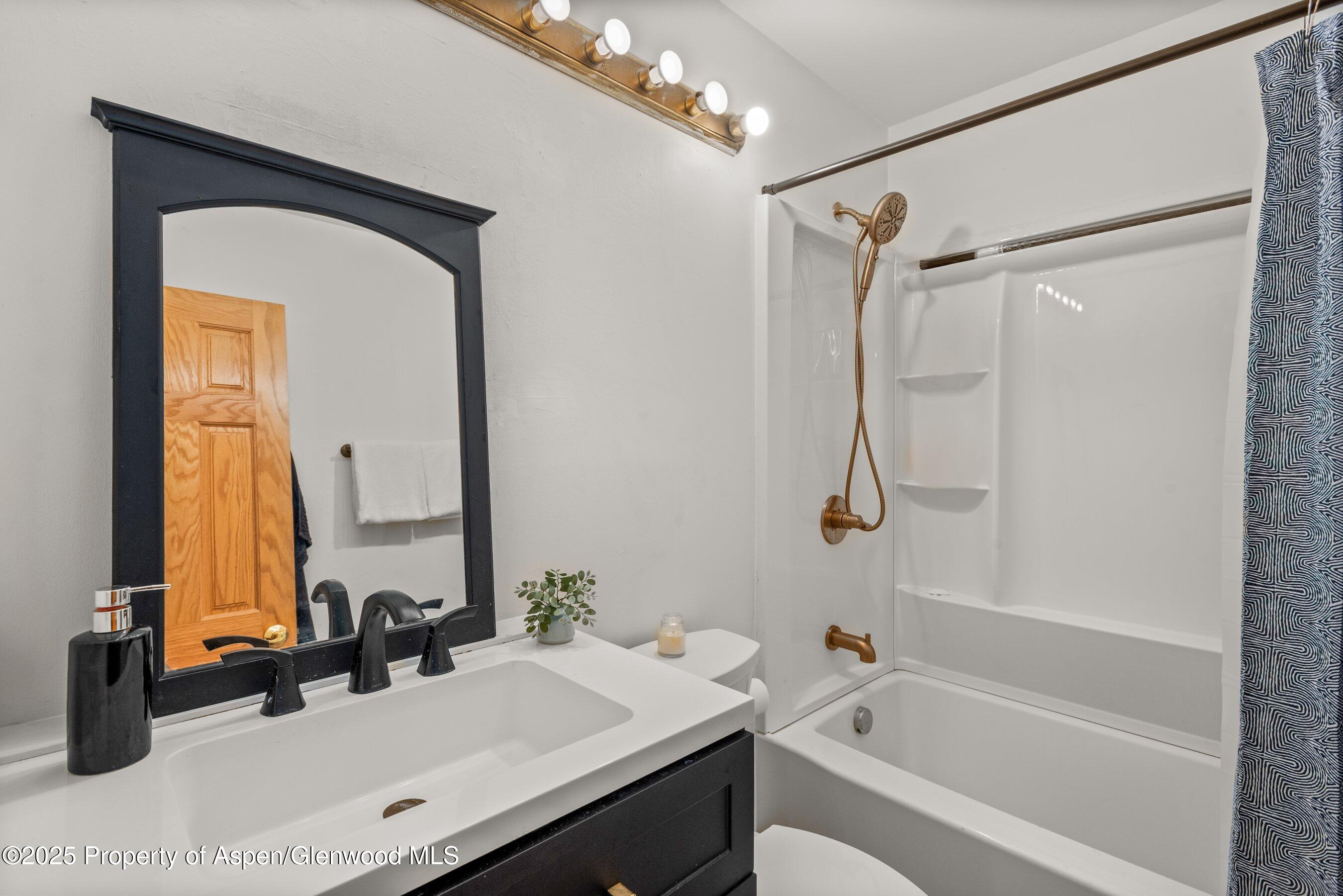 331 Holland Hills Road, Unit 5 Basalt, CO 81621 - Photo 10 of 19 a bathroom with a tub sink and mirror