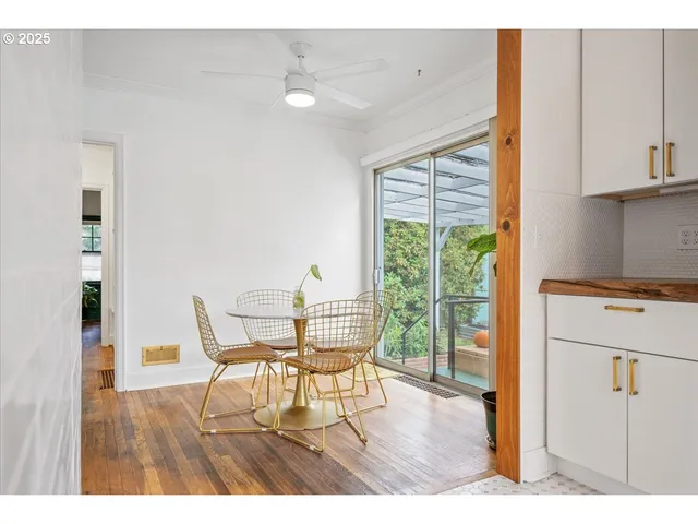 a view of a dining room with furniture and a window