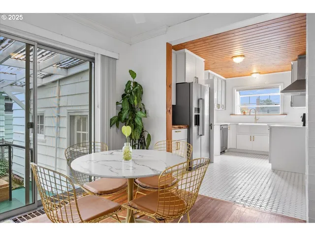a view of a dining room with furniture and a potted plant