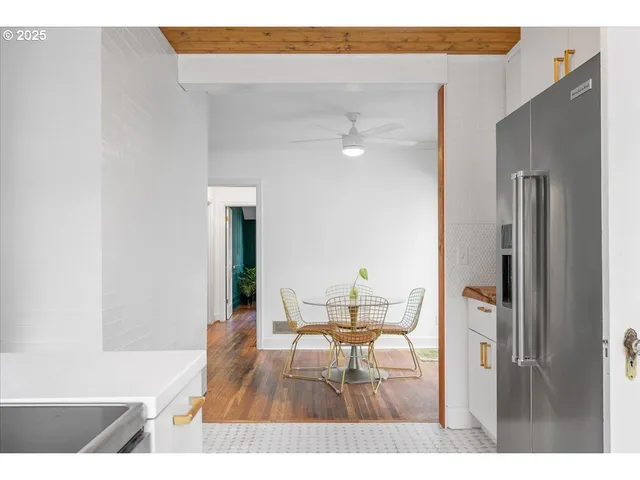 a living room with furniture and a dining table