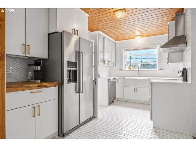 a kitchen with a refrigerator and a sink