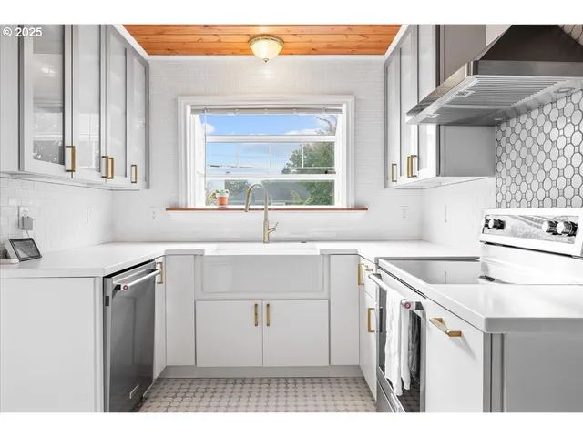 a kitchen with a sink stove and cabinets