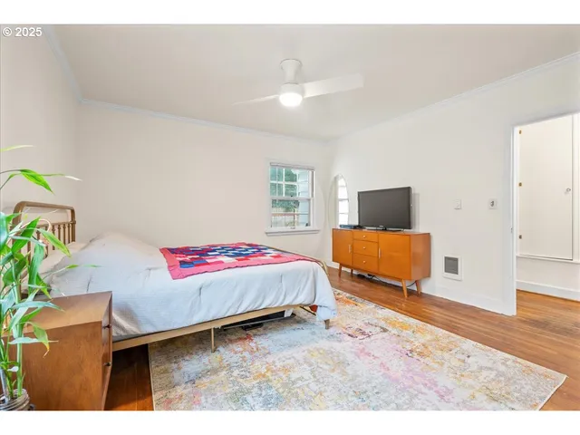 a bedroom with furniture and flat screen tv