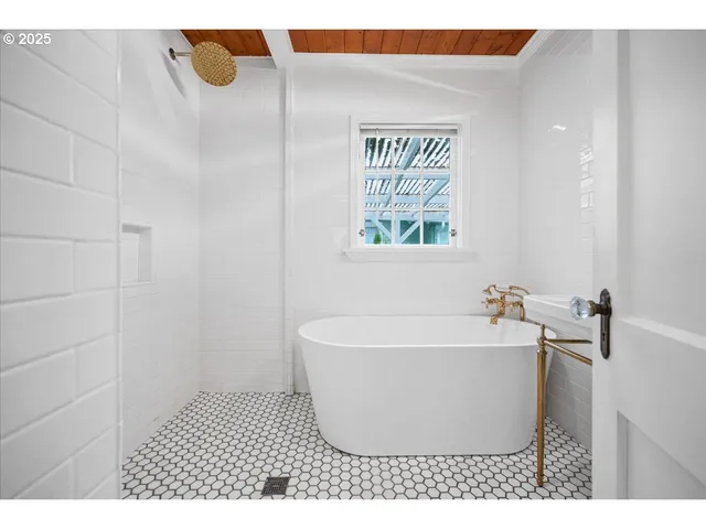 a white bath tub sitting next to a white sink