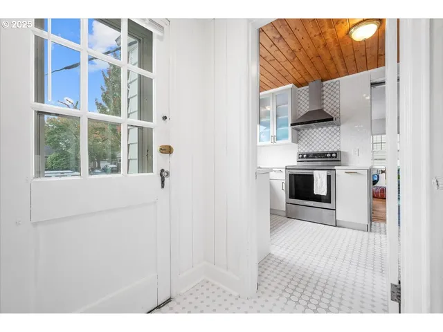 a kitchen with a white stove top oven and a dishwasher