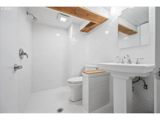 a bathroom with a sink mirror and toilet