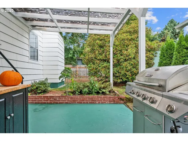 a view of a backyard with plants and outdoor seating