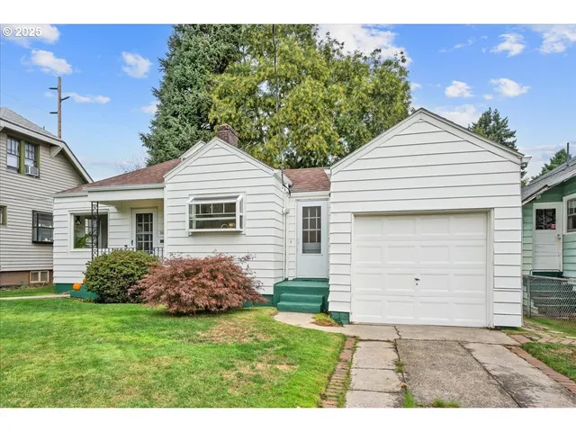 a front view of a house with a garden