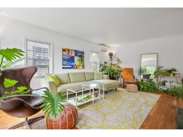 a living room with furniture a rug and a painting