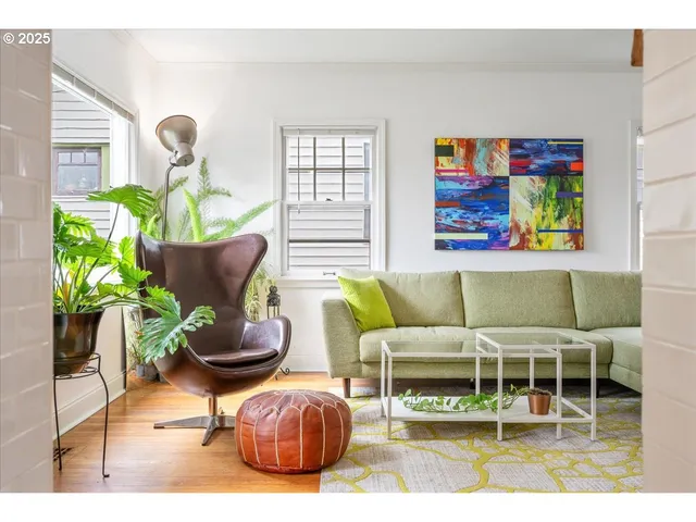 a living room with furniture and a potted plant