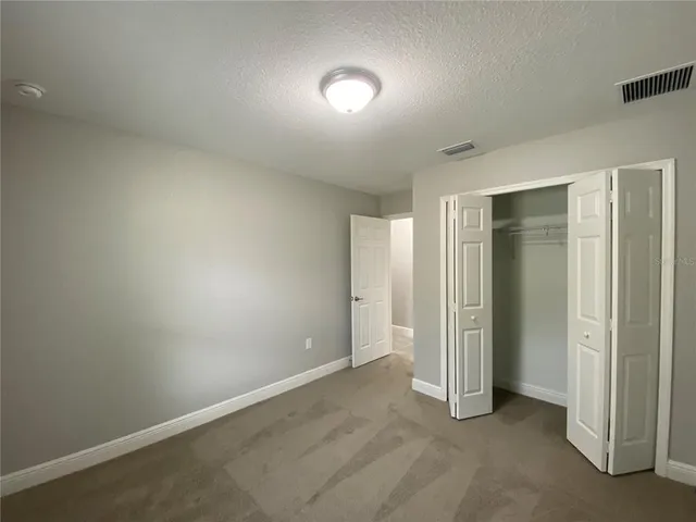 an empty room with closet area