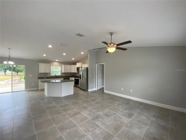 a view of a kitchen with a sink stainless steel appliances and cabinets