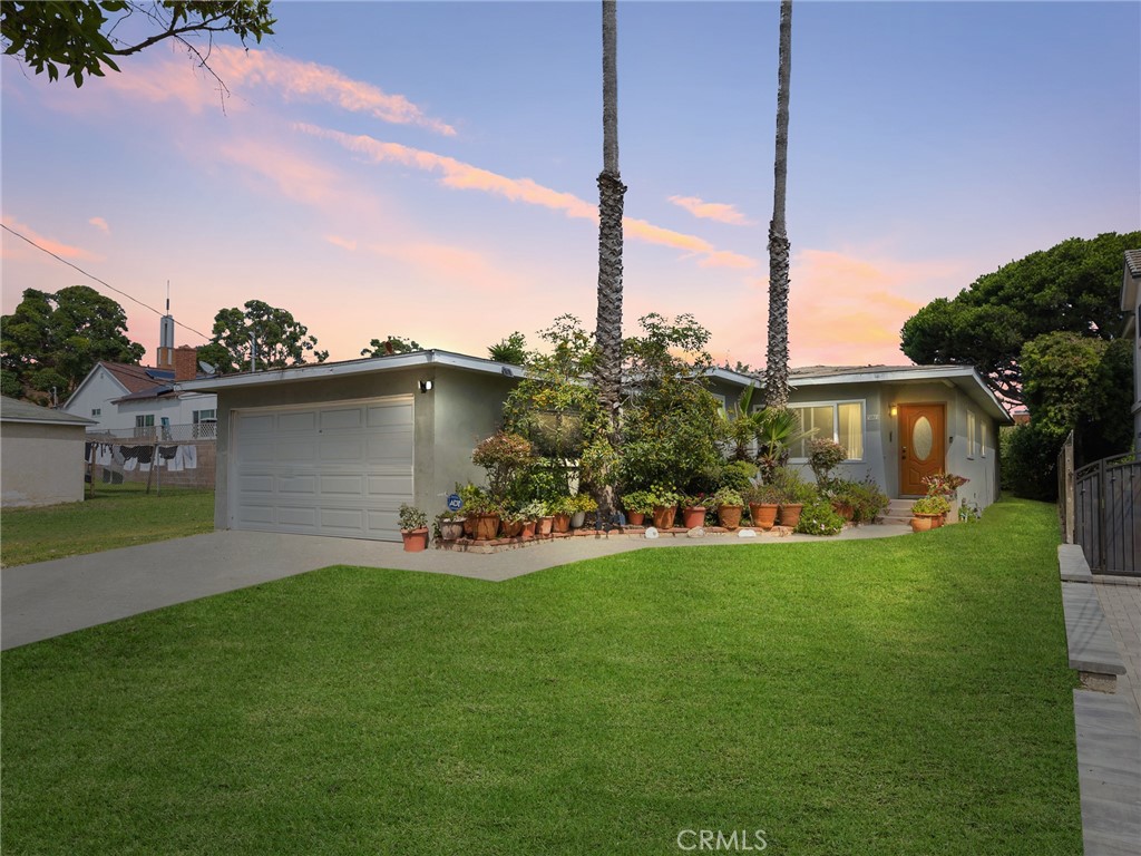 a view of a house with a yard and many windows