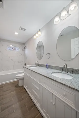 a bathroom with a double vanity sink and a mirror