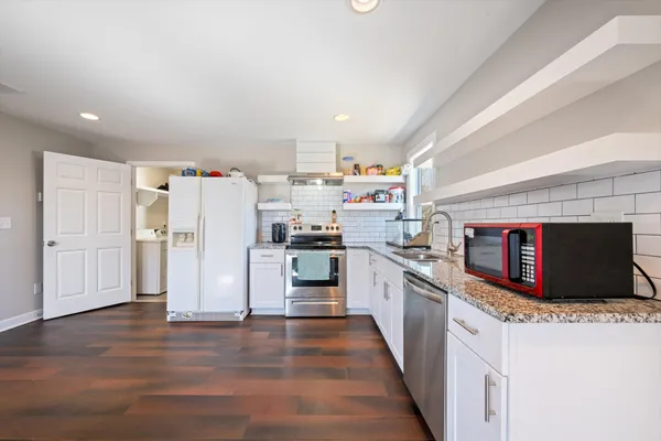 a kitchen with stainless steel appliances a refrigerator a stove and a sink