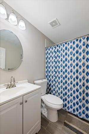 a bathroom with a sink toilet and a mirror