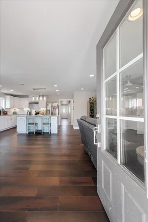a room with lots of wooden furniture and a view of living room