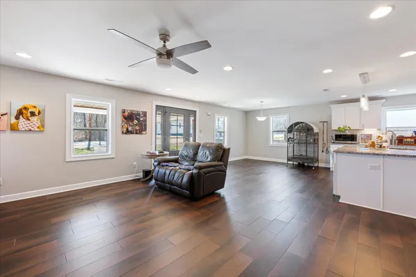 a living room with furniture and a wooden floor