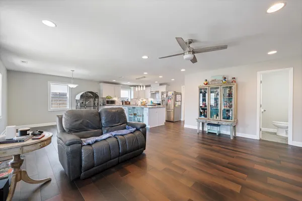 a living room with furniture and kitchen view