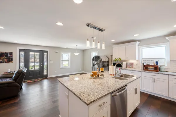 a kitchen with counter top space sink and center island