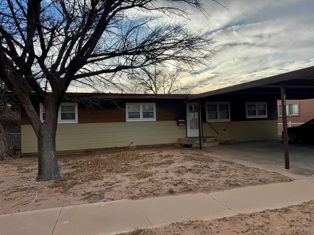 a view of a house with a tree