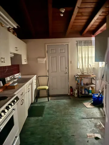a kitchen with sink cabinets and stove top oven