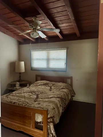 a bedroom with a bed dresser and a window