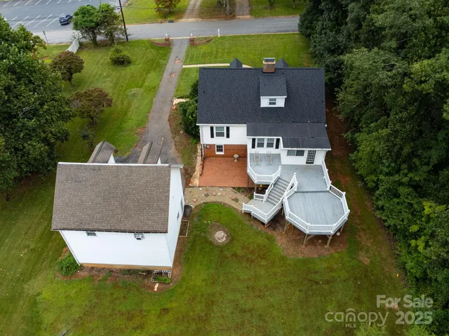an aerial view of a house with pool yard and outdoor seating