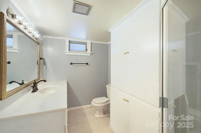 a white toilet sitting next to a bathroom sink