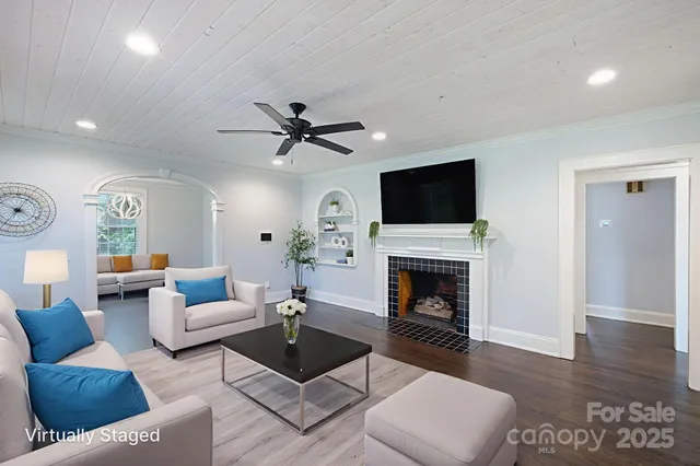 a living room with furniture fireplace and window