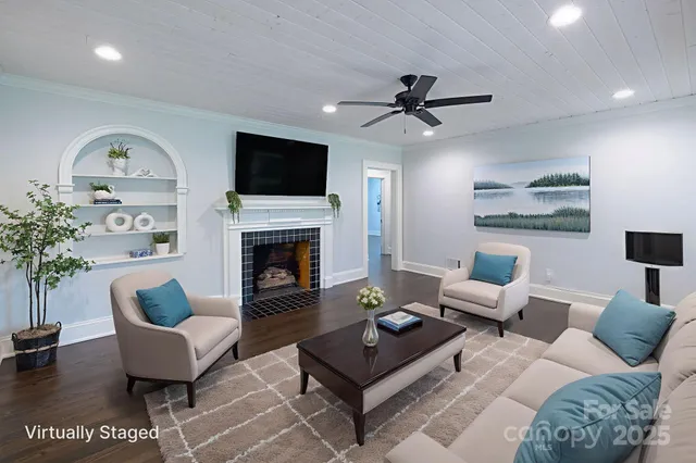 a living room with furniture a fireplace and a flat screen tv