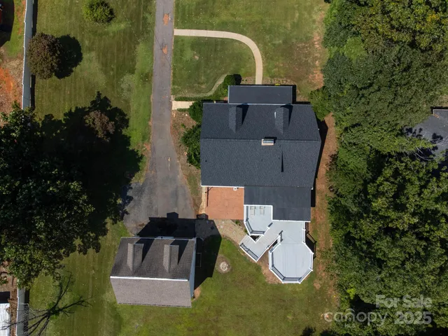 an aerial view of a house with outdoor space