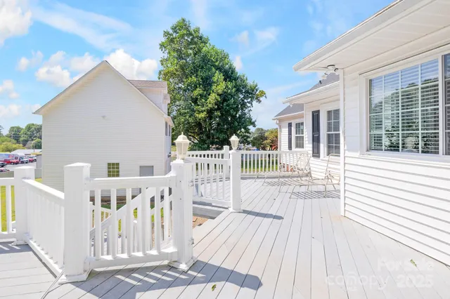 a view of a house with wooden deck