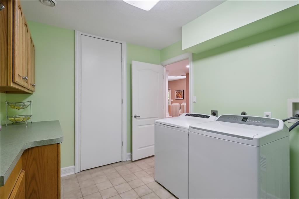 7091 Pinehurst Drive Presto, PA 15142 - Photo 21 of 29 a utility room with cabinets washer and dryer