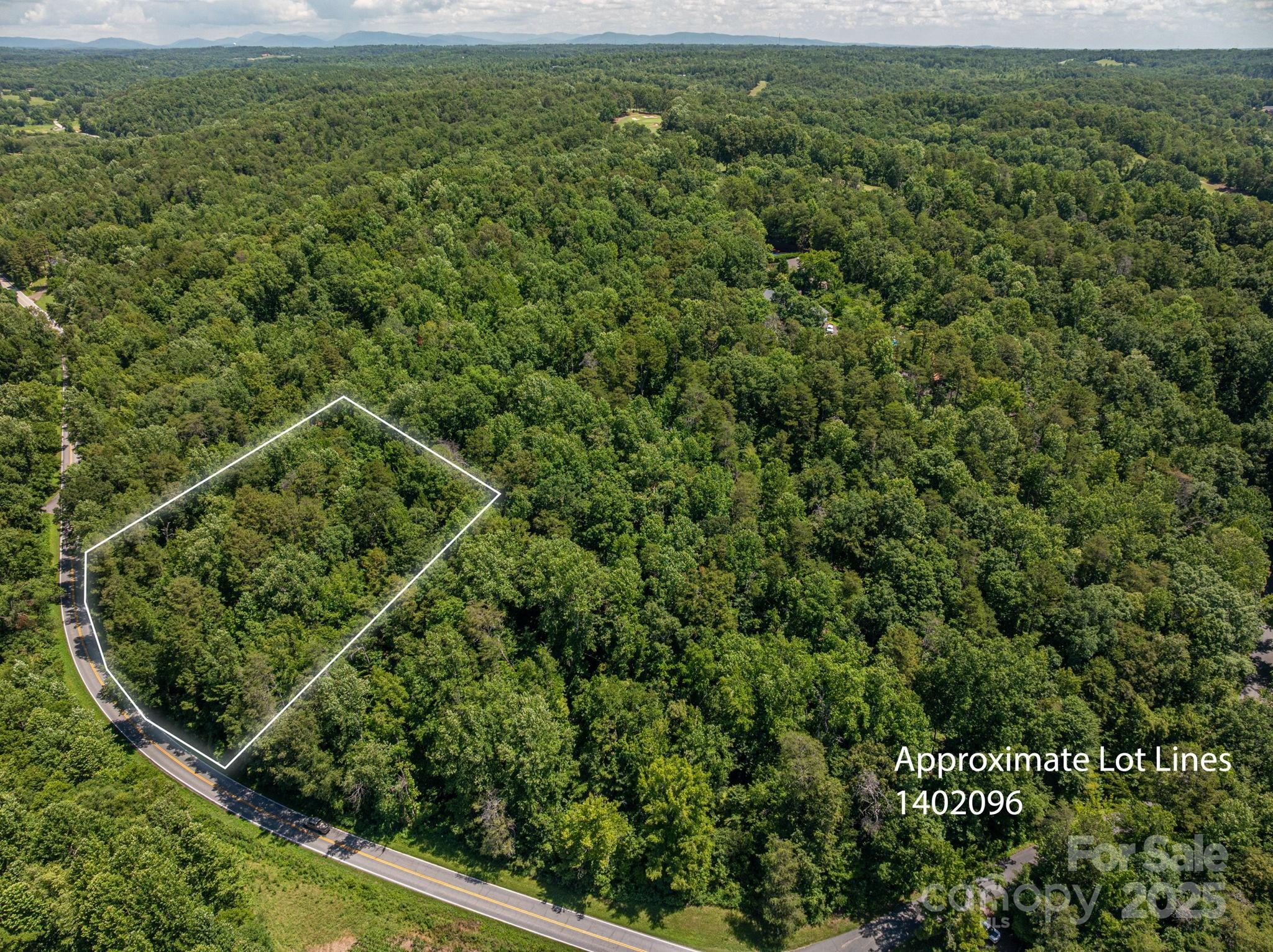 a view of a field of grass and trees