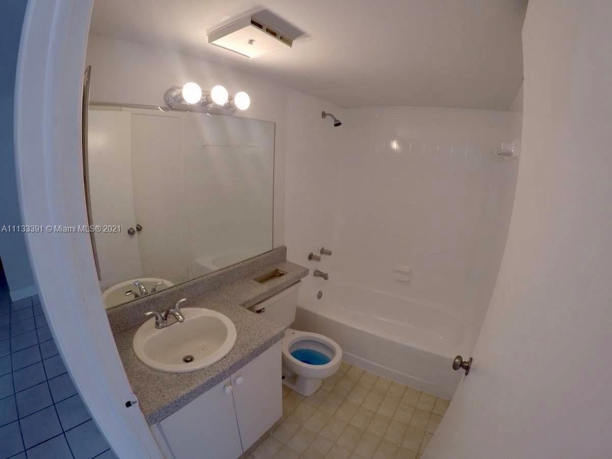 11780 Southwest 18th Street, Unit 2292 Miami, FL 33175 - Photo 8 of 10 a bathroom with a sink a toilet and shower