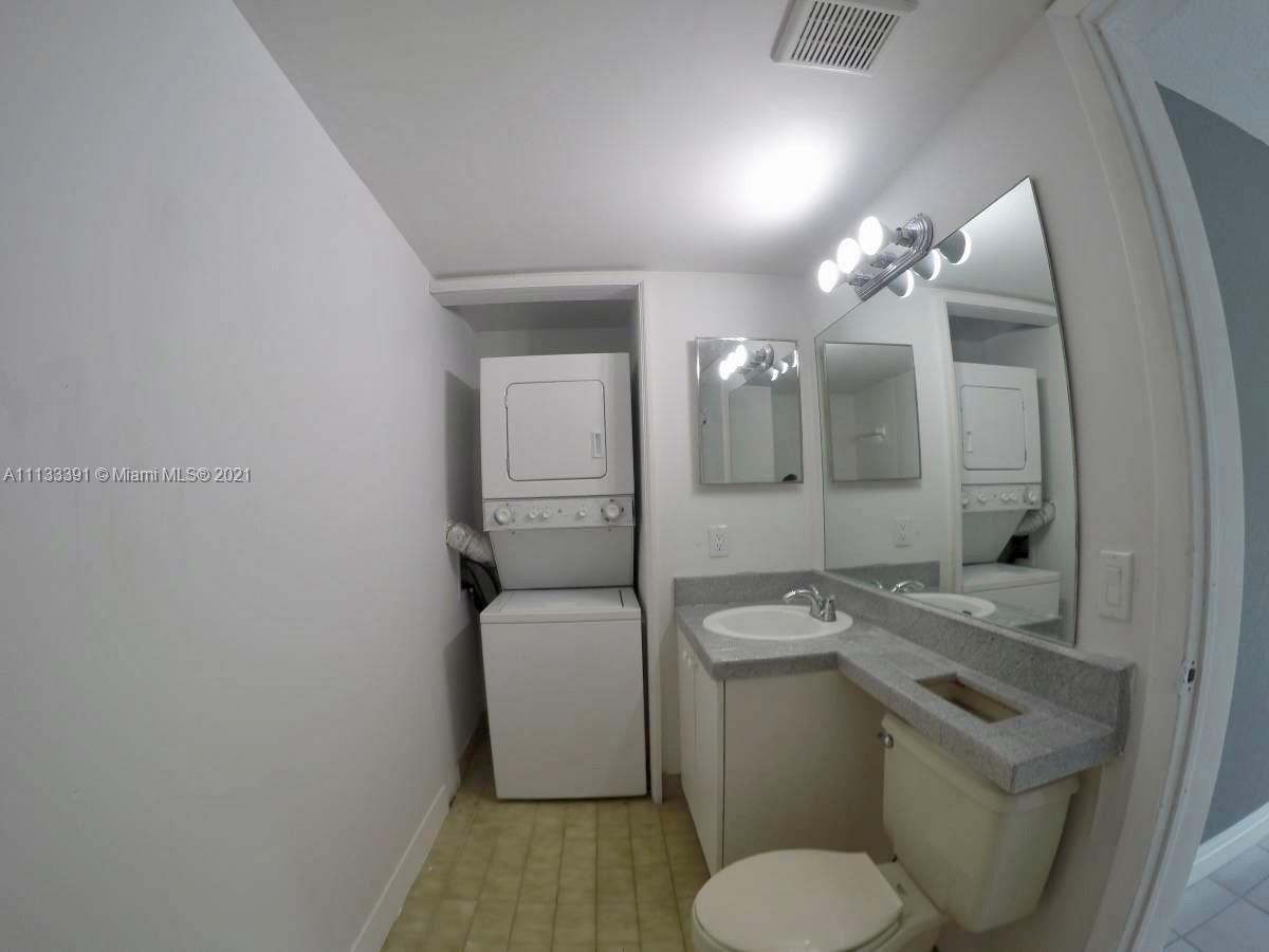 11780 Southwest 18th Street, Unit 2292 Miami, FL 33175 - Photo 10 of 10 a bathroom with a granite countertop toilet sink and mirror
