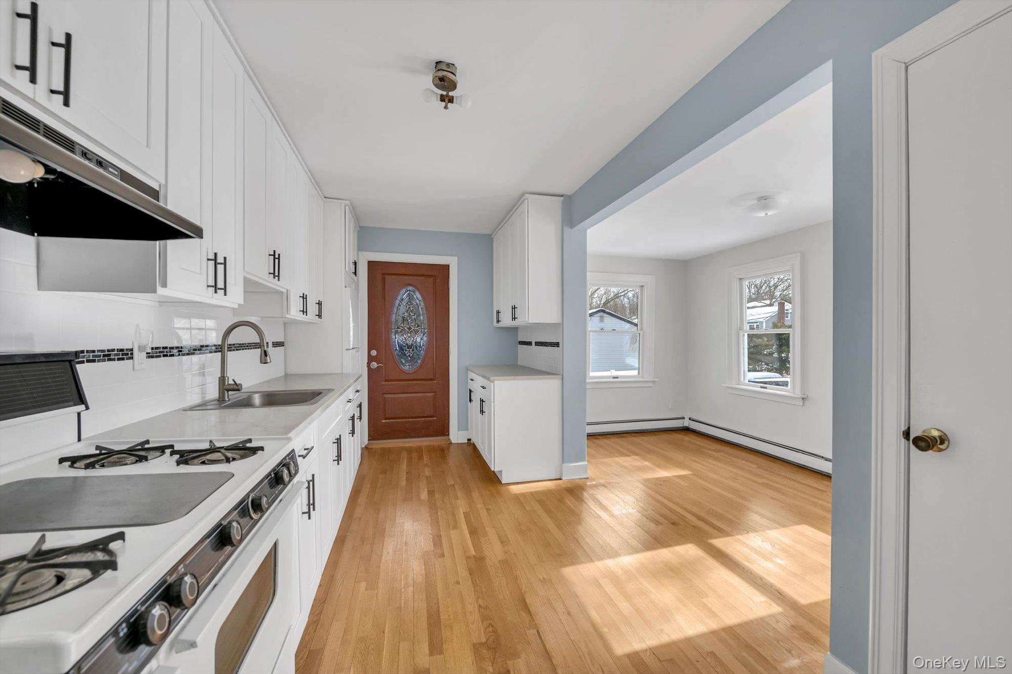 1117 St Johnland Road Kings Park, NY 11754 - Photo 4 of 20 Bright white kitchen with Dining area
